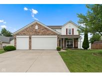 Charming two-story home with brick and white siding, a well-manicured lawn, and an attached two-car garage at 6927 Rose Tree Ct, Indianapolis, IN 46237