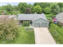 Charming home featuring a manicured lawn and two-car garage, perfect for Gathering living at 7025 Chimney Rock Ct, Indianapolis, IN 46217