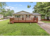 Charming single-story home featuring a large front yard and inviting wood deck at 724 Alexander St, Greenwood, IN 46143