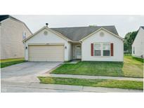 Charming single-story home with a well-maintained lawn and attached two-car garage at 8148 Gathering Cir, Indianapolis, IN 46259
