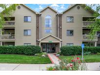 Well-maintained condo building with manicured landscaping and accessible entrance at 8720 Yardley Ct # 108, Indianapolis, IN 46268