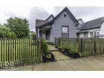 Charming two-story home featuring a well-maintained lawn and inviting walkway at 1201 Villa Ave, Indianapolis, IN 46203