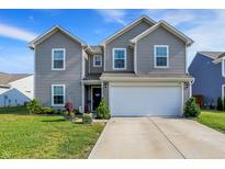 Charming two-story home featuring a two-car garage and well-maintained lawn at 1375 Crabapple Rd, Franklin, IN 46131