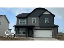 Two-story home with a two-car garage, gray siding, and black accents at 16465 Mount Logan Rd, Noblesville, IN 46060