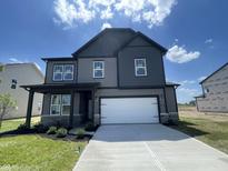 Beautiful new two-story home featuring a two-car garage, stone accents, and a well-manicured lawn at 16465 Mount Logan Rd, Noblesville, IN 46060