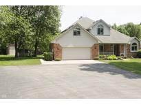 Two story home featuring a brick and vinyl exterior, two car garage, and front porch at 1739 S County Road 450 E, Avon, IN 46123