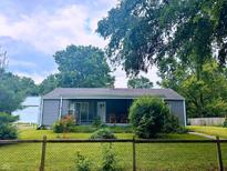Charming single-story home with a cozy front porch and beautifully maintained lawn at 196 Bakemeyer St, Indianapolis, IN 46225