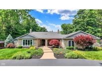 Charming single-story home with stone facade, landscaped front yard and mature trees at 3528 E 116Th St, Carmel, IN 46033