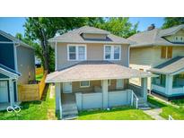 Charming two-story home featuring a covered front porch and well-maintained landscaping at 418 Eastern Ave, Indianapolis, IN 46201
