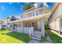 Inviting two-story home featuring a covered front porch and well-maintained landscaping at 420 Eastern Ave, Indianapolis, IN 46201