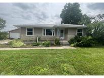 Charming home featuring a well-maintained lawn and pleasing stone and siding combination at 4363 Roosevelt Dr, Columbus, IN 47201