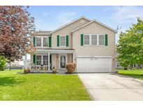 Charming two-story home featuring green shutters, a well-manicured lawn, and an attached two-car garage at 5631 N Peppereel Way, McCordsville, IN 46055