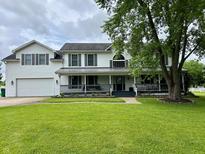 Charming two-story home with a well-manicured lawn and a welcoming front porch perfect for relaxing at 7195 W 700 N, Fairland, IN 46126