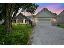 Charming single-Gathering home featuring a two-car garage, brick accents, and well-maintained landscaping at 11418 Geist Valley Dr, Indianapolis, IN 46236