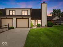 Inviting townhome with attached two-car garage and well-manicured lawn at 1205 Cypress Dr, Shelbyville, IN 46176