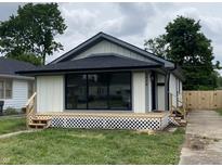 Charming renovated bungalow showcasing new siding, deck and manicured lawn, inviting comfort and modern curb appeal at 1429 Udell St, Indianapolis, IN 46208
