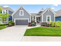 Charming home featuring a gray exterior, well-manicured lawn, and inviting curb appeal with a gray two car garage at 1505 Avondale Dr, Westfield, IN 46074
