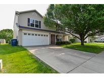 Charming two-story home featuring an attached garage, complemented by a well-maintained lawn and mature trees at 15524 Follow Dr, Noblesville, IN 46060