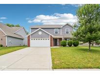 Charming two-story home with a well-manicured lawn and an attached two-car garage at 1739 Wedgewood Pl, Avon, IN 46123