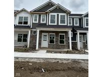 New construction townhome with stone facade, covered entry, and white trimmed windows at 19541 Grassy Branch Rd, Westfield, IN 46074