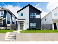 Two-story home with a striking two-tone exterior and well-manicured lawn at 2014 W Michigan St, Indianapolis, IN 46222