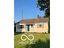 Charming single-story home with green lawn and neutral siding, enhanced by a traditional chimney at 2028 Gilmore St, Columbus, IN 47201