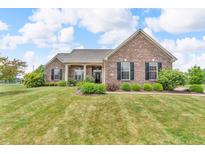 Charming single-story brick home featuring a well-manicured lawn and inviting front porch at 2948 Chalbury Dr, Plainfield, IN 46168