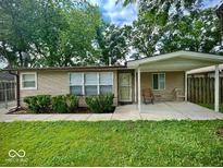 Charming home featuring a covered front porch, tidy landscaping, and a well-maintained lawn at 3161 Normandy Rd, Indianapolis, IN 46222