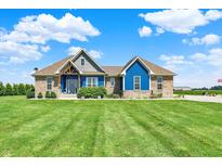 Charming brick and blue paneled home featuring a well-manicured lawn and inviting architectural details at 3301 N 200 W, Franklin, IN 46131