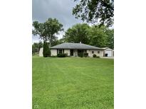 Charming single-story home with a large, well-maintained front lawn and mature trees in a serene setting at 386 Shadow Hill Dr, Greenwood, IN 46142