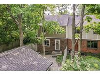 Exterior home view showing a lovely yard, brick accents, and mature landscaping surrounding the property at 392 Aspen Dr, Carmel, IN 46032