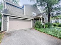 Charming home with a two-car garage, lovely landscaping, and mature trees at 4635 Stansbury Ct, Indianapolis, IN 46254