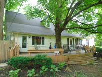 Spacious backyard deck is perfect for entertaining, with a wraparound bench and direct access to the home at 4747 Guion Rd, Indianapolis, IN 46254