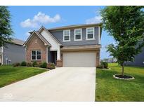 Charming two-story home with brick and siding, featuring a well-manicured lawn and attached two-car garage at 4832 W Safford Dr, New Palestine, IN 46163