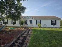 Charming single-story home with a well-manicured lawn and inviting walkway at 496 Tague St, Greenfield, IN 46140