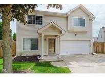 Charming two-story home with a well-manicured lawn, attached two-car garage and inviting front porch at 565 Cembra Dr, Greenwood, IN 46143