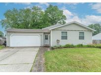 Charming single-story home with attached garage, green lawn, and mature trees at 6837 Littleton Dr, Indianapolis, IN 46221