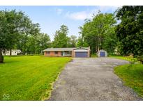 Charming ranch style home featuring a spacious lawn and attached two car garage at 9378 N County Road 75 W, Lizton, IN 46149