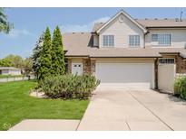 Charming townhome featuring an attached two-car garage and manicured lawn at 9406 Avon Strand # Apt A, Avon, IN 46123
