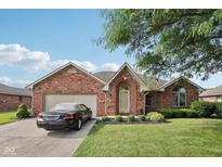 Charming brick home with manicured lawn, two-car garage, and well-maintained landscaping at 1027 Plum St # 39, Brownsburg, IN 46112