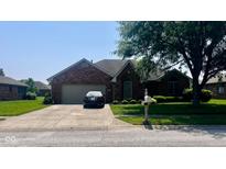 Charming brick home with well-manicured lawn, two-car garage, and inviting front entrance at 1027 Plum St # 39, Brownsburg, IN 46112
