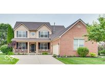Charming two-story home featuring a covered front porch and a well-maintained lawn at 12679 Chargers Ct, Fishers, IN 46037
