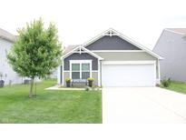 Charming one-story home with a well-manicured lawn and a two-car garage, offering great curb appeal at 12901 N Collett Way, Camby, IN 46113