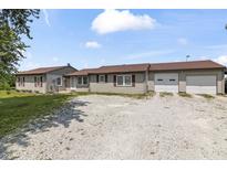 Charming single-story home features a gravel driveway, attached two-car garage, and well-maintained landscaping at 13666 E 166Th St, Noblesville, IN 46060