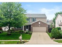 Charming two-story home with a well-manicured lawn, brick accents and attached two-car garage at 14446 Chapelwood Ln, Fishers, IN 46037