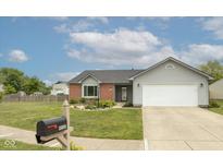 Charming single-story home with manicured lawn and attached two car garage at 18005 Gasparilla Ct, Westfield, IN 46062
