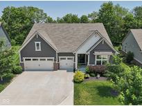 Charming home featuring a three-car garage and well-manicured landscaping at 18998 Beverly Shones Ln, Noblesville, IN 46062
