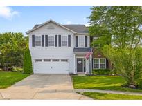 Charming two-story home featuring a well-maintained lawn and an attached two-car garage at 2247 Rolling Hill Ct, Columbus, IN 47201