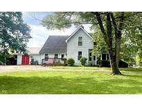 Charming two-story home with a front porch and a spacious, well-manicured lawn, offering a welcoming curb appeal at 317 W State Road 44, Franklin, IN 46131