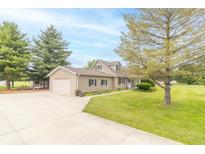 Inviting home with a charming yard, mature trees, and an attached garage offering both beauty and functionality at 391 W 500 S, Anderson, IN 46013